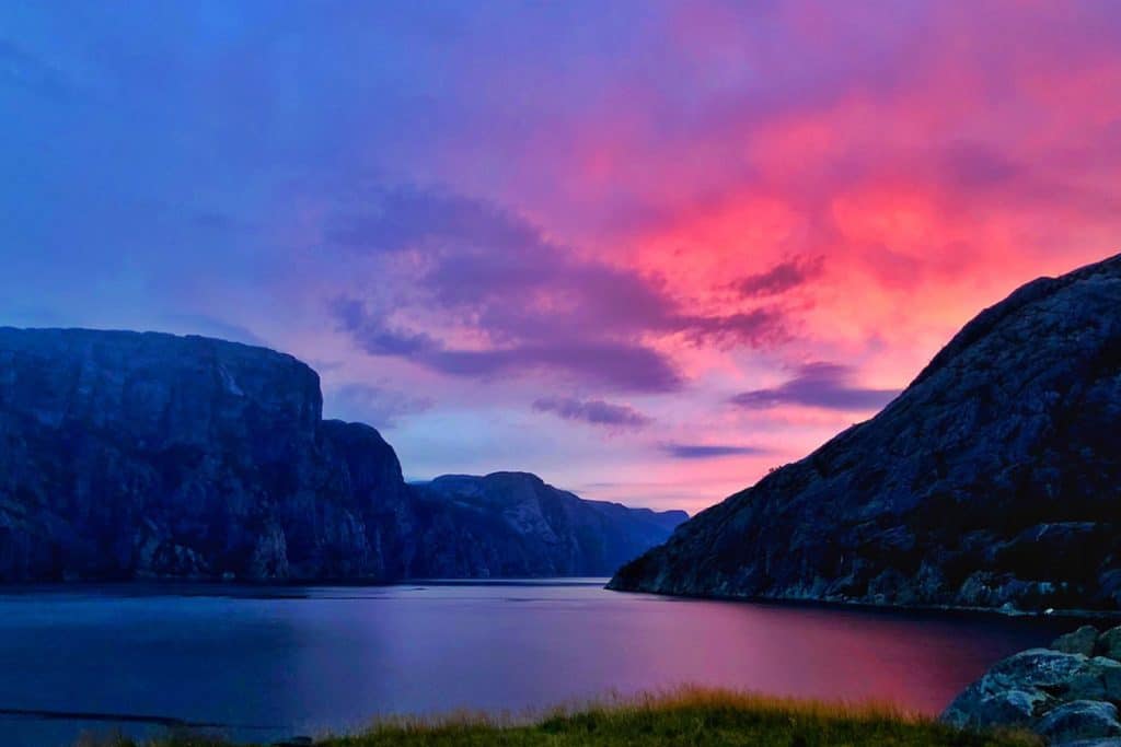 A view of the sunset over a Norwegian fjord while wild camping in Norway with a motorhome.