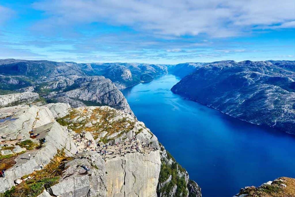 A stunning view of the expansive fjords filled with blue water that you'll find in Norway!