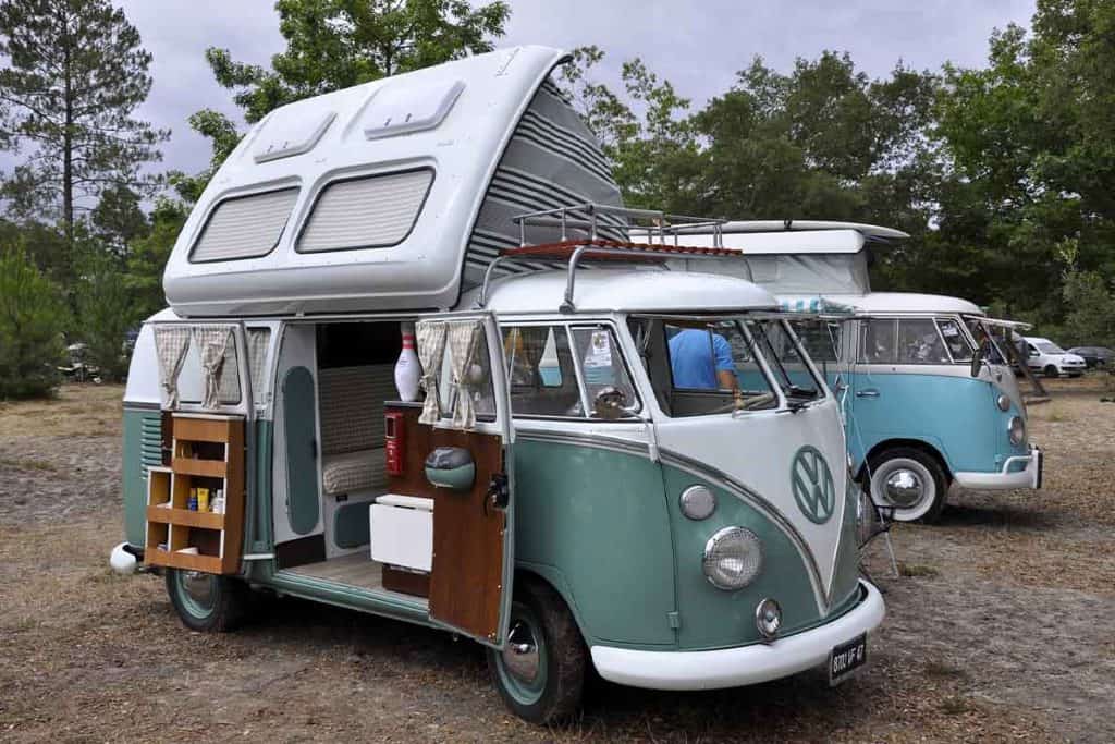 A small, green, VW campervan. 