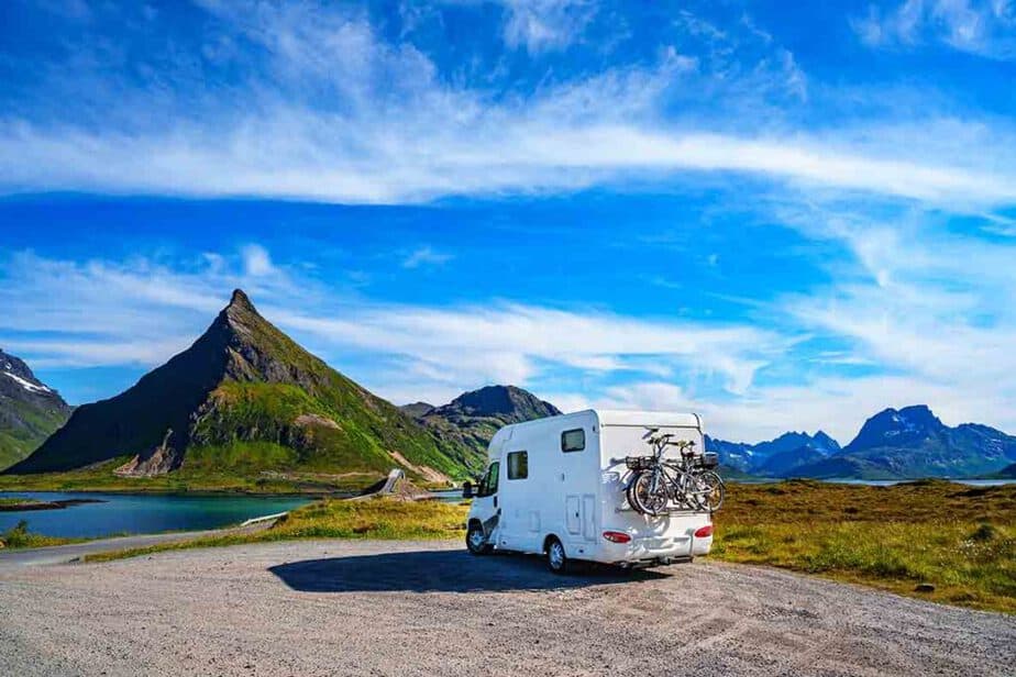 A small motorhome that is under 6m and parked in front of the mountains, 