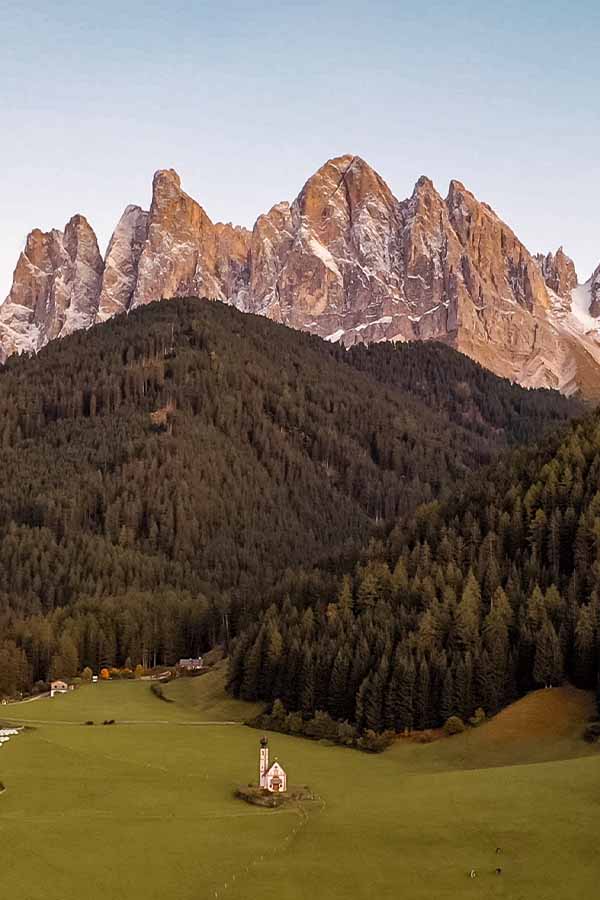 St Johann Church Dolomites- church in field with mountains behind- famous Instagram church